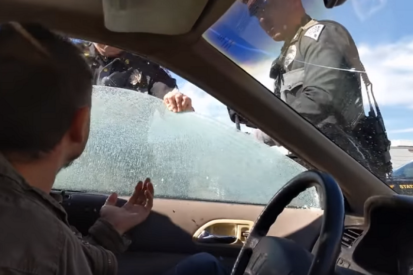 Breaking the car window. Man shooting thru a Window in a car. Police for fixing Violations on a car. Car Window Breaking Scene. The Police Officer checking car Seats from films.